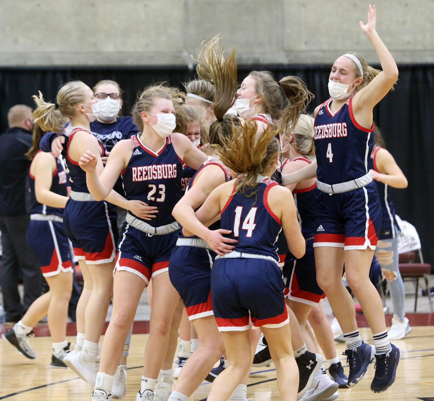 WIAA state girls basketball photo: Reedsburg players gather to celebrate their Division 2 state semifinal win.
